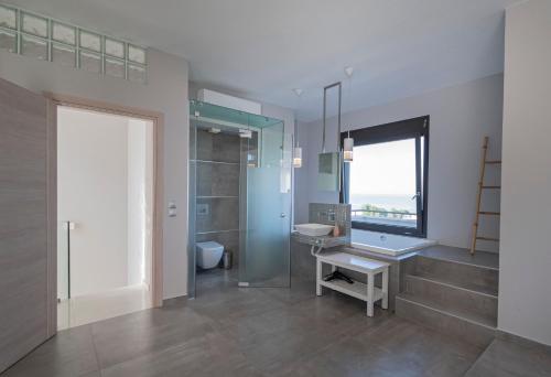 a bathroom with a sink and a mirror at Bellevue Villas with private pool in Hanioti