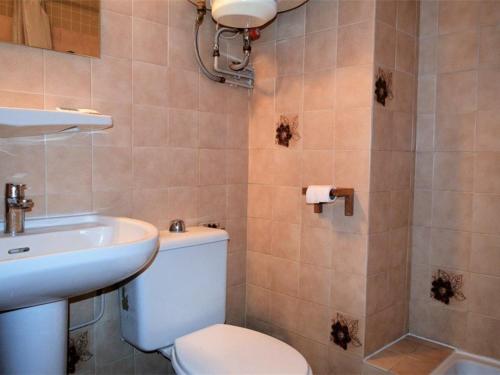 a bathroom with a toilet and a sink at Studio Font-Romeu-Odeillo-Via, 1 pièce, 4 personnes - FR-1-580-86 in Font-Romeu-Odeillo-Via