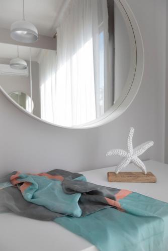 a bathroom with a mirror and a towel on a table at Bellevue Villas with private pool in Hanioti