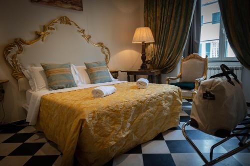 a bedroom with a large bed with a yellow bedspread and a bag at San Giorgio Rooms in Genova