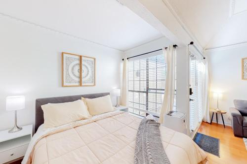 a bedroom with a large bed and a large window at Restful City Living, Unit B in Dallas