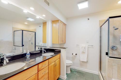 a bathroom with two sinks and a shower and a toilet at Restful City Living, Unit B in Dallas