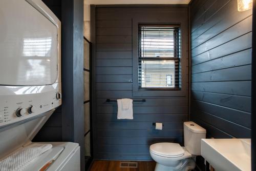 a blue bathroom with a toilet and a sink at Chalet Amelia Lake View HotTub Fireplace Arcade in Dandridge