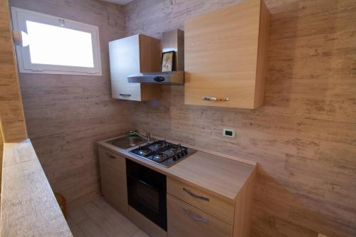 a small kitchen with a stove and a window at Il Posto in Pulsano