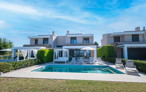 a house with a swimming pool in the yard at Bellevue Villas with private pool in Hanioti