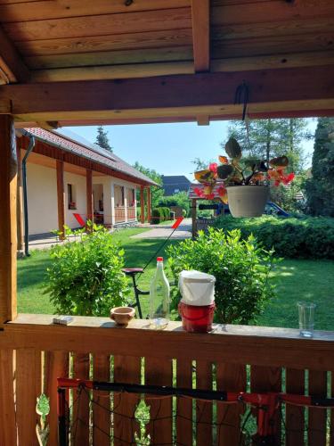 a view of a yard from a porch with a house at Zergeboglár Vendégház in Szilvásvárad