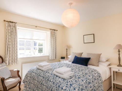 a bedroom with a bed with towels on it at Bay Tree Cottage in Kingsbridge