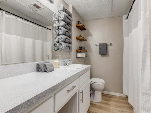 a white bathroom with a sink and a toilet at 6 min to UT Southwestern_Fast Wi-fi in Dallas