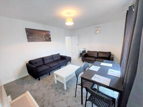 a living room with a couch and a table at 3 bedroom Flat in Hoxton London in London
