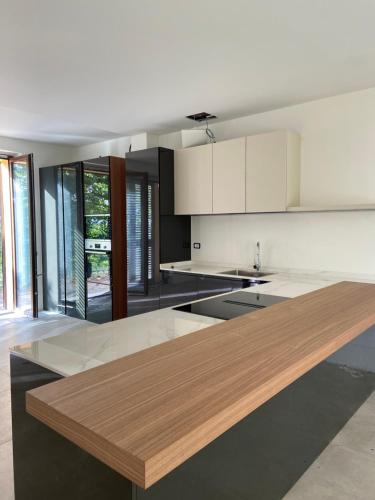 a kitchen with a wooden counter top in a room at Villa panoramica sulle colline del Monferrato in Calamandrana
