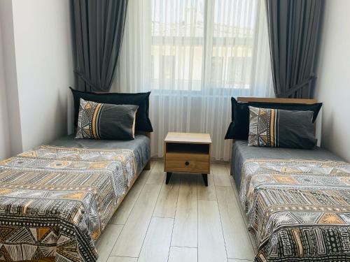 a room with two beds and a window at Apart Angel Suit 5 in Nevsehir