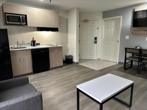 a kitchen and living room with a couch and a table at MainStay Suites Columbia Harbison in Columbia