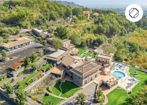 an aerial view of a large mansion with a swimming pool at Antico Borgo Petralia in Zafferana Etnea