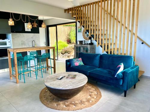 - un salon avec un canapé bleu et une table dans l'établissement Vacoa - Villa Salba. Panoramic view., à L'Étang-Salé