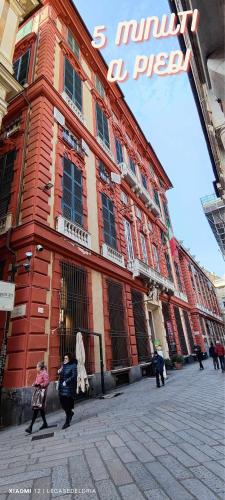 a group of people walking in front of a building at La Brignoletta Le Case del Dria Acquario suite in Genova