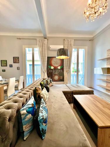 uma grande sala de estar com um sofá e uma mesa em Le Parisien - Chic 2BR City Centre Escape em Tânger