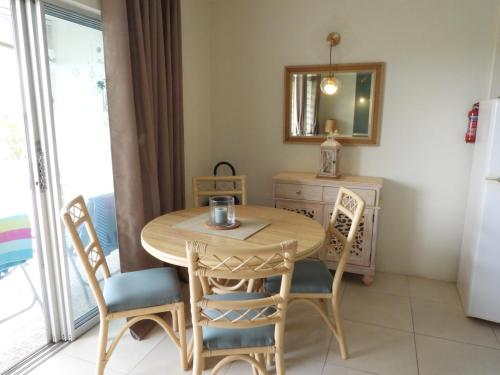 a dining room with a table and chairs and a mirror at Golden View Apartment in Saint James