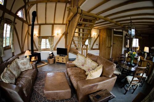 a living room with a couch and a fireplace at Ebony Cottage in Tenbury