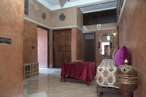 a room with a table and a chair and a mirror at CHEZ MANAR in Ouarzazate