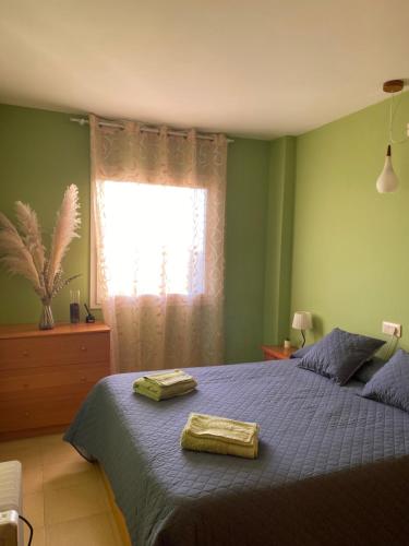 a bedroom with a bed with two towels on it at Apartamento MARINA PLAYA, primera linea de mar in Blanes