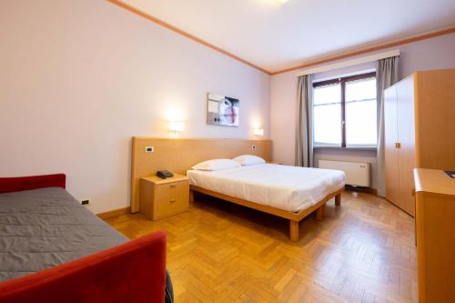 a hotel room with a bed and a window at Hotel La Fertè in Asti