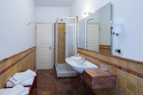 a bathroom with a sink and a mirror at Hotel La Fertè in Asti