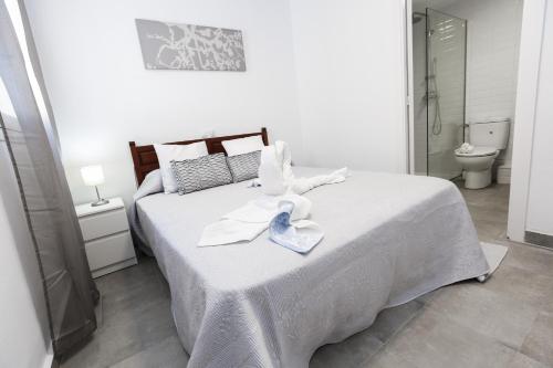 a bedroom with a bed with a towel on it at NEW VALENCIA 2 Planetcostadorada in Salou