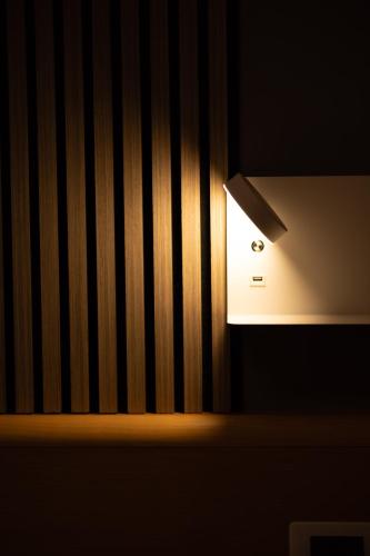 a light on the side of a wall at Hotel La Fertè in Asti