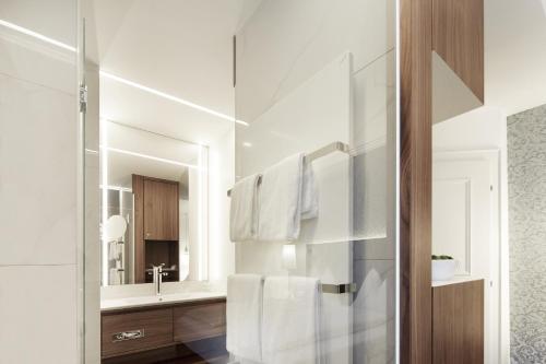 a bathroom with white towels hanging on a wall at Gasthof Hotel Zweimüller in Grieskirchen