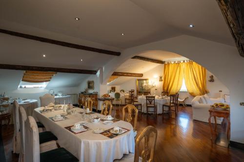 a dining room with white tables and chairs at Morali Palace in Genova