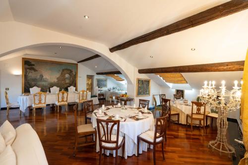 a dining room with white tables and chairs at Morali Palace in Genova