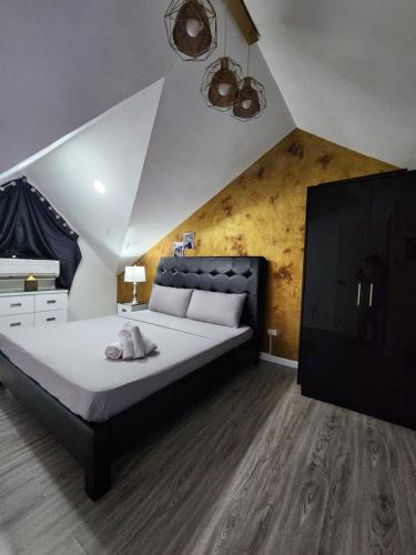 a bedroom with a large bed and a tv at Kandi Suites 2BR with private Jacuzzi 500 Mbps internet in Angeles