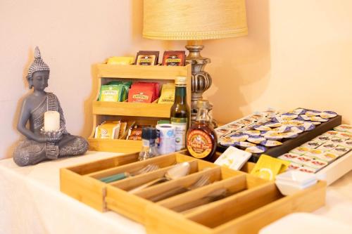 a table with a tray of food and a bottle of wine at Hotel La Fertè in Asti