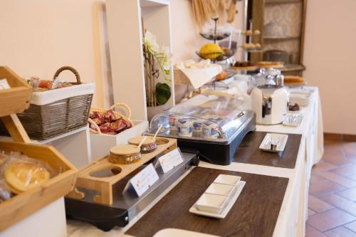 a store with a counter with food on it at Hotel La Fertè in Asti