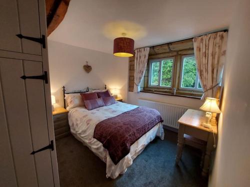 a bedroom with a bed and a window at Old Town Hall Holiday Cottage in Hebden Bridge