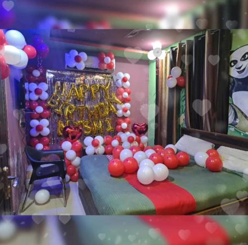 a room with a bed with a bunch of balloons at Abhinandan House stay in Prayagraj