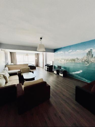 a living room with a large painting of the ocean at Meatsa Hotel in Kŭrdzhali