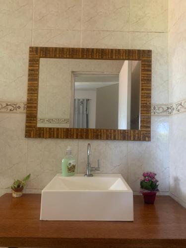 a white sink in a bathroom with a mirror at Sítio Maranata Vale das Montanhas in Monte Alegre do Sul