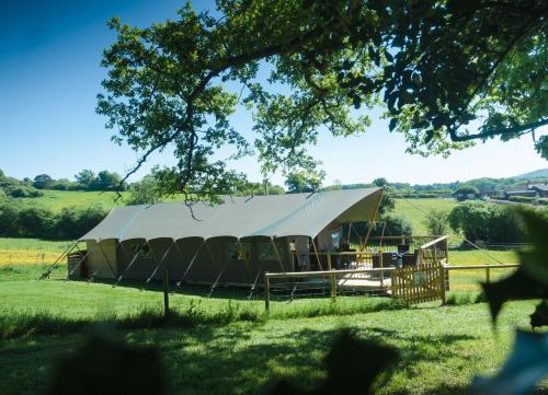 a large tent in the middle of a field at Black Pig Retreats Luxury Glamping in Shaftesbury