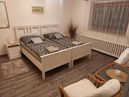 a bedroom with a large white bed in a room at Apartmán Vysočina in Zvole