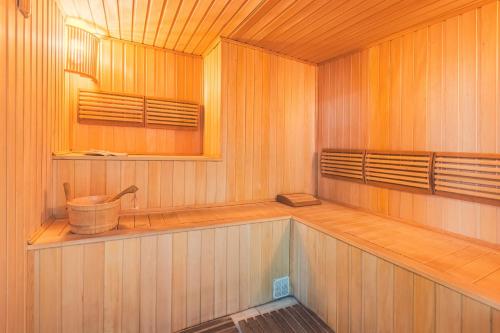 a sauna with a tub and a sink in it at Passage Art Hotel in Baku