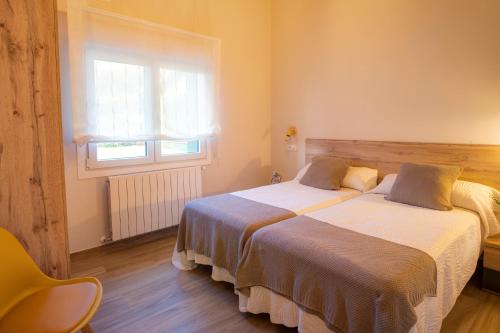 Cama o camas de una habitación en Apartamentos Alto Ubiro