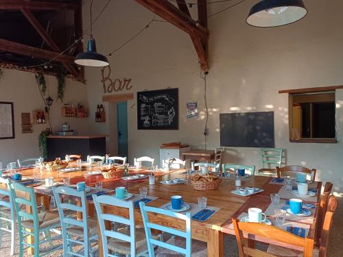 a large wooden table and chairs in a room at Chambres d'Hôtes Domaine du Bourg in Gannay-sur-Loire