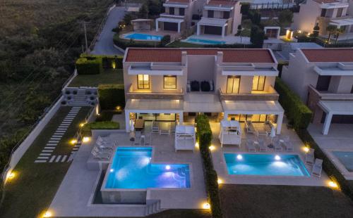 an aerial view of a house with two swimming pools at Bellevue Villas with private pool in Hanioti