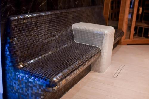 a bench made out of a brick wall at Jarzębinowy Resort & SPA in Braniewo