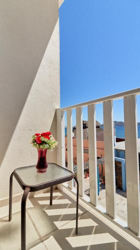 a vase with flowers sitting on a table on a balcony at Bungalows Las Hamacas in San Patricio Melaque