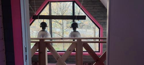 two birds are looking out of a window at Ostoja Karkonoska in Podgórzyn