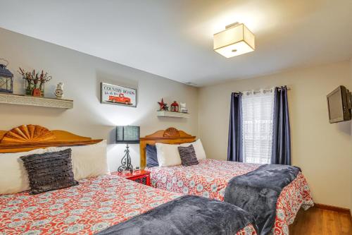 a bedroom with two beds and a window at Troy Apartment with Hot Tub, Pool Table and Fire Pit! in Troy