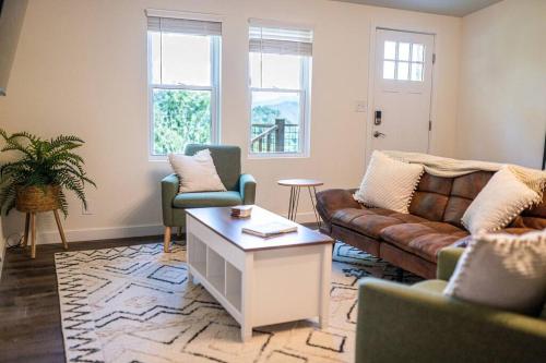 a living room with a couch and two chairs at Modern Mountain Cabin - Spectacular Views at 3100 ft in Waynesville