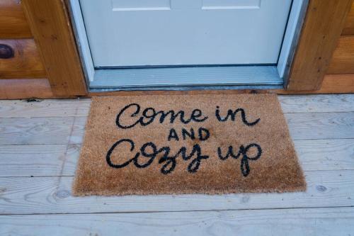 a door sign that says come in and cozy up at Modern Mountain Cabin - Spectacular Views at 3100 ft in Waynesville